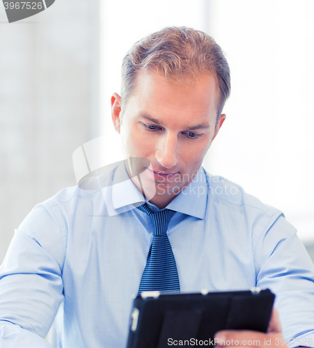 Image of businessman with tablet pc in office