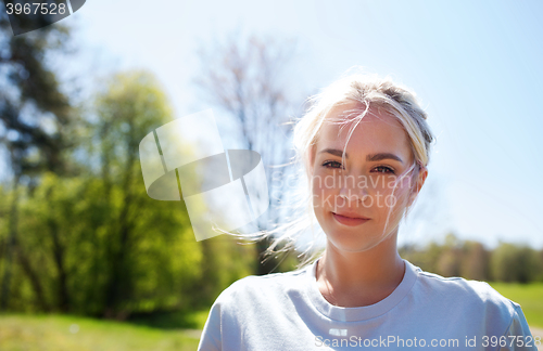 Image of happy young volunteer woman outdoors