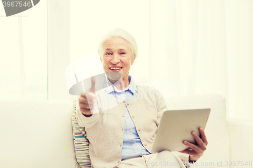 Image of senior woman with tablet pc showing thumbs up 