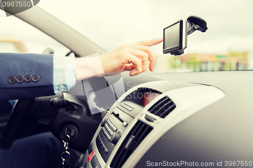 Image of close up of man with gps navigator driving car