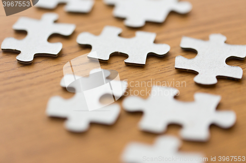 Image of close up of puzzle pieces on wooden surface