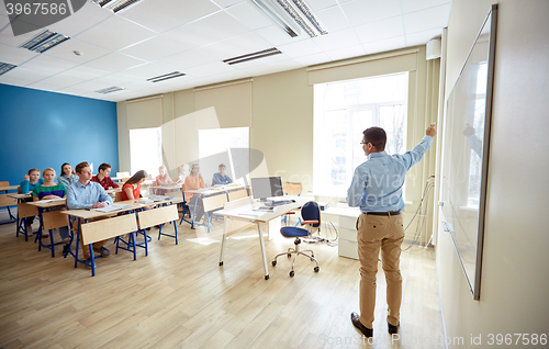 Image of students and teacher at school white board