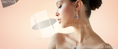 Image of beautiful asian woman with earring and pendant