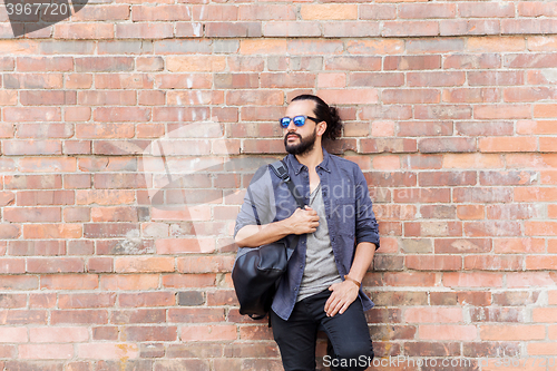 Image of happy man with backpack standing at city street