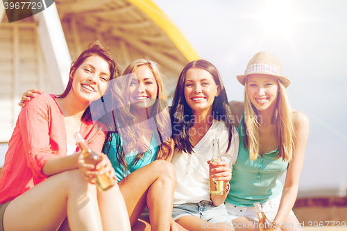 Image of girls with drinks on the beach