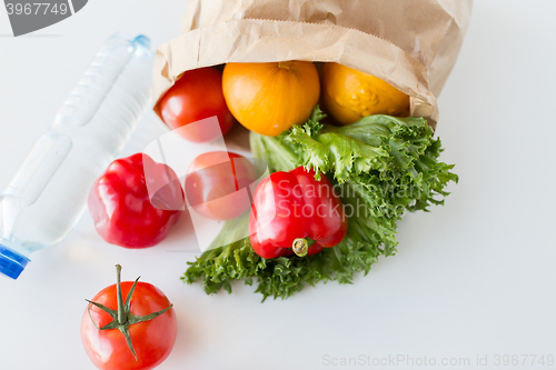 Image of basket of fresh vegetables and water at kitchen