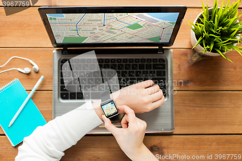 Image of close up of woman with smart watch and laptop