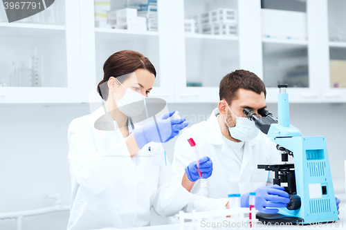 Image of young scientists making test or research in lab