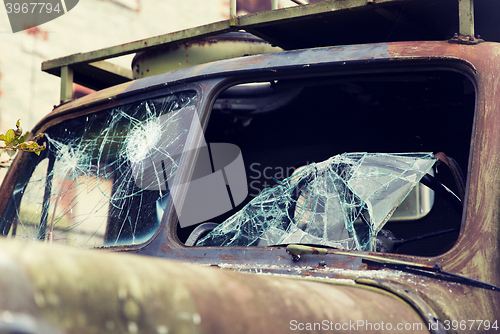 Image of war truck with broken windshield glass outdoors