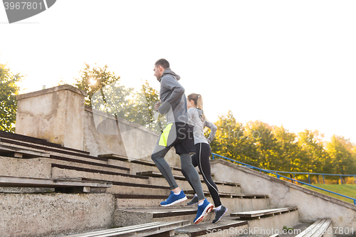 Image of couple running upstairs on stadium