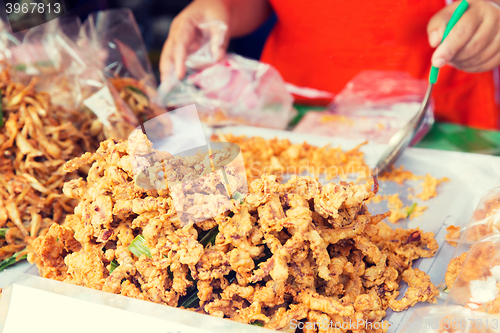 Image of close up of cook hands and snacks at street market