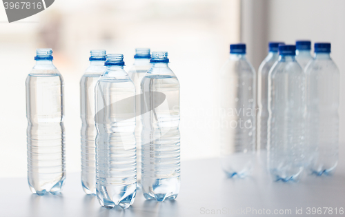 Image of close up of bottles with drinking water on table