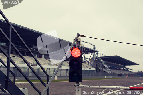 Image of red traffic lights and road sign on race track