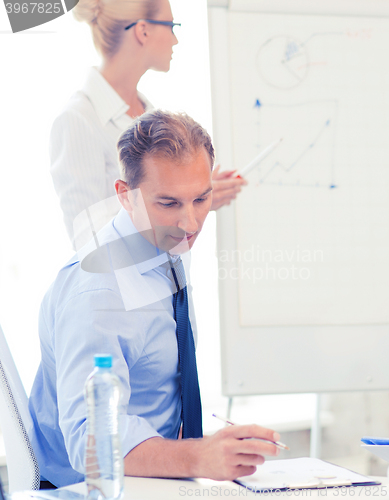 Image of business team discussing something in office