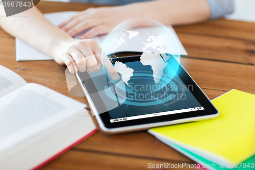 Image of close up of student with tablet pc and notebook