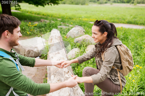 Image of smiling couple with backpacks hiking