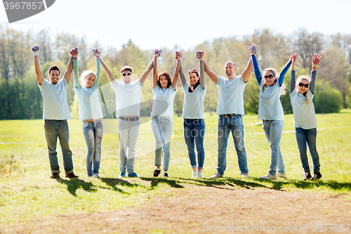 Image of group of volunteers celebrating success in park