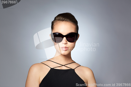 Image of beautiful young woman in elegant black sunglasses