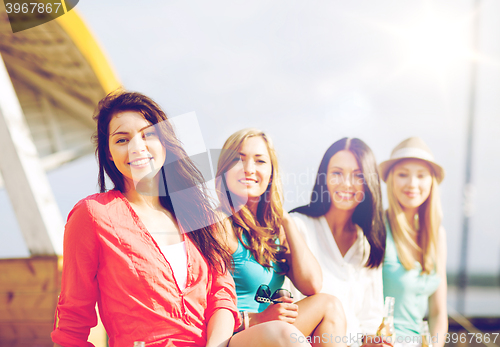 Image of girls with drinks on the beach