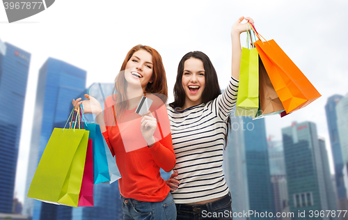 Image of teenage girls with shopping bags and credit card