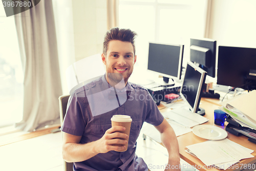 Image of happy creative male office worker drinking coffee