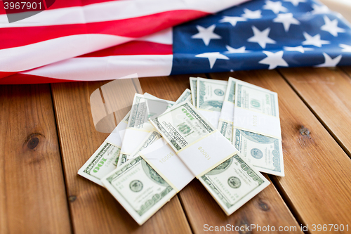 Image of close up of american flag and dollar cash money