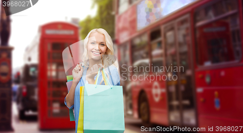 Image of woman with shopping bags over london city street