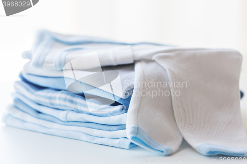 Image of close up of baby boys clothes for newborn on table