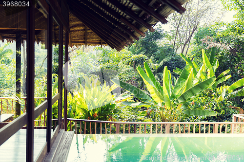 Image of swimming pool and bungalow at hotel resort