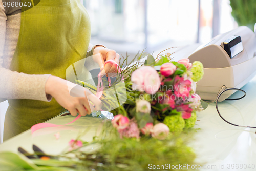 Image of close up of woman making bunch at flower shop