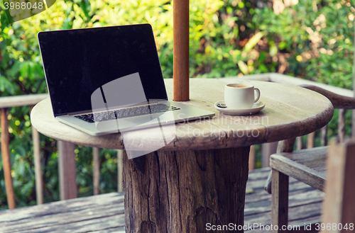 Image of close up of laptop computer on table at hotel