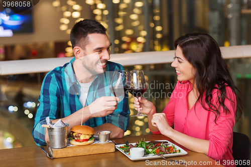 Image of happy couple dining and drink wine at restaurant