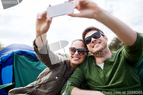 Image of couple of travelers taking selfie by smartphone