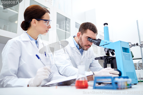 Image of young scientists making test or research in lab