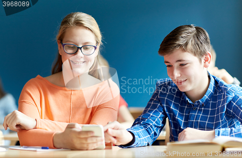 Image of students with smartphone texting at school