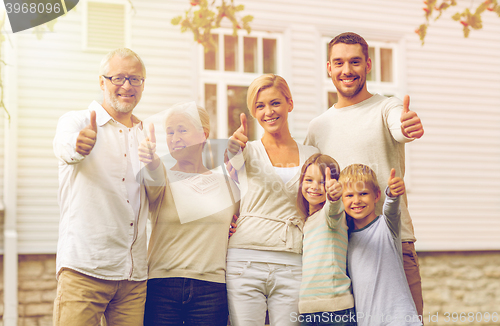 Image of happy family in front of house outdoors