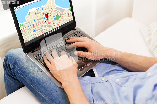 Image of close up of man typing on laptop computer at home