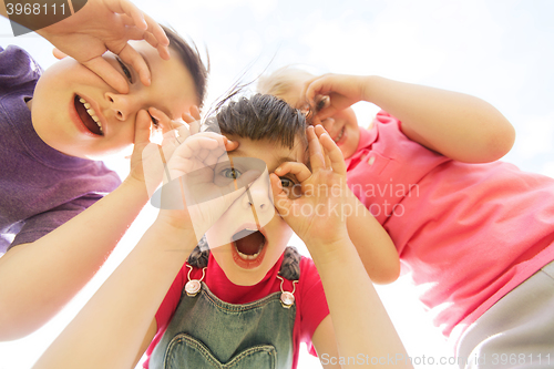 Image of group of kids having fun and making faces outdoors