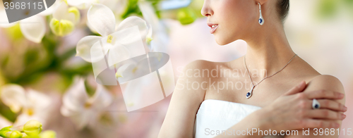 Image of beautiful woman with earring, ring and pendant