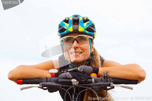 Image of Young girl riding bicycle outside. Healthy Lifestyle.