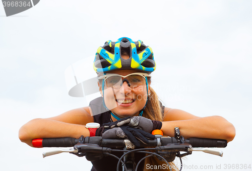 Image of Young girl riding bicycle outside. Healthy Lifestyle.