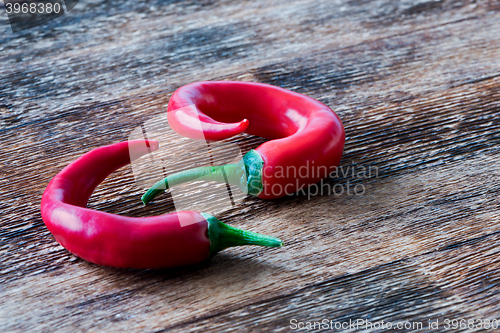 Image of Chili peppers on wooden background