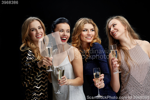 Image of happy women with champagne glasses over black