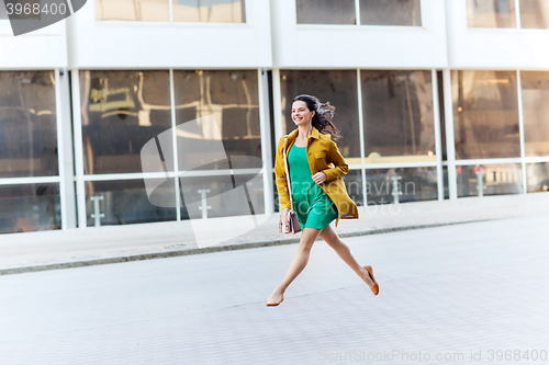 Image of happy young woman or teenage girl on city street