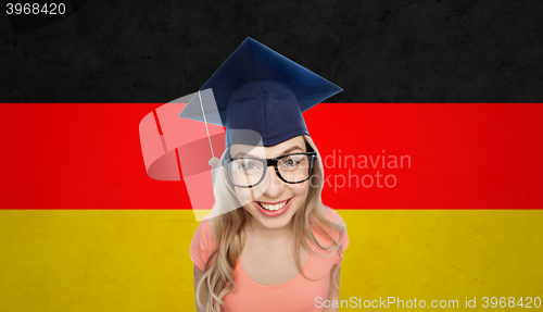 Image of smiling young student woman in mortarboard