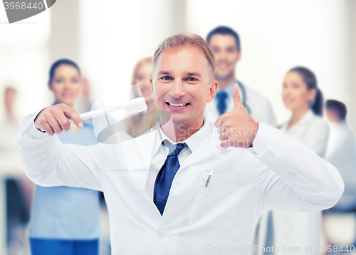 Image of dentist with toothbrush in hospital