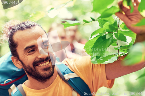 Image of group of smiling friends with backpacks hiking