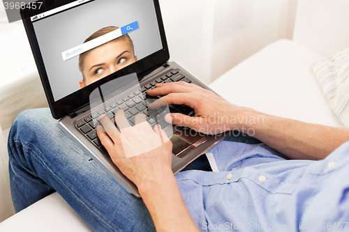 Image of close up of man typing on laptop computer at home