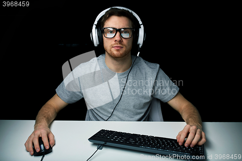 Image of man in headset playing computer video game