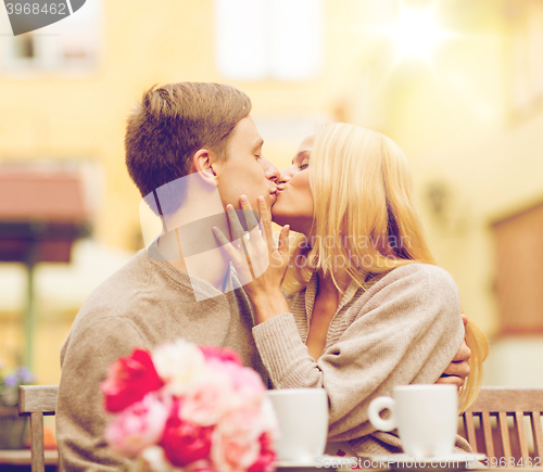 Image of romantic happy couple kissing in the cafe
